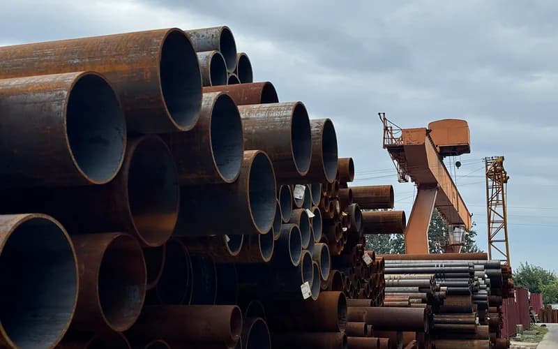 Stacked steel pipes in an outdoor yard